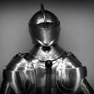 Close-up shot of vintage medieval knight armor in monochrome.