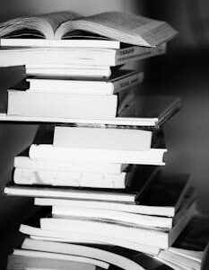 A monochrome image of a tall stack of books symbolizing education and knowledge.